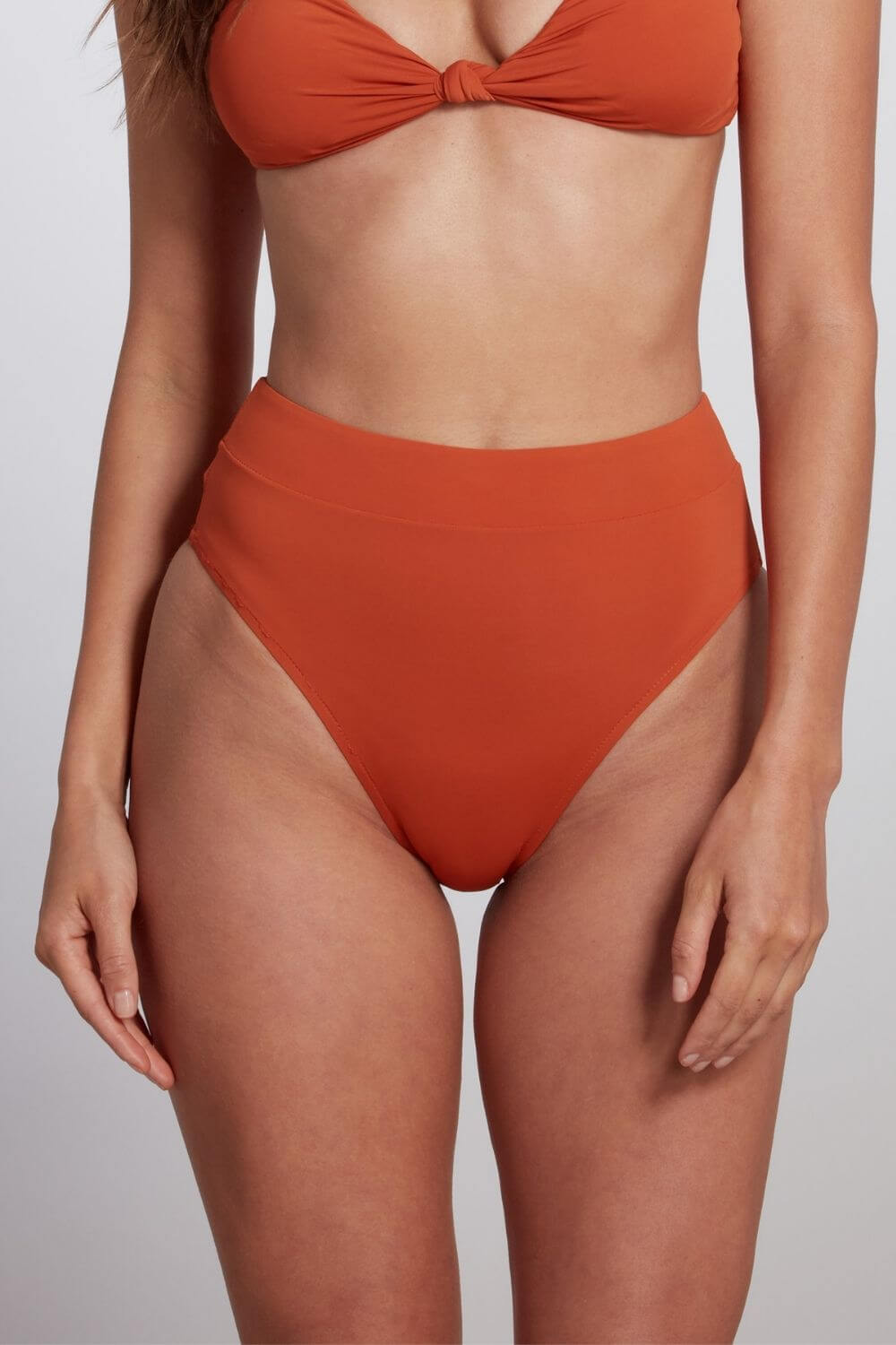High cut, high waist bikini bottom in orange rust. 