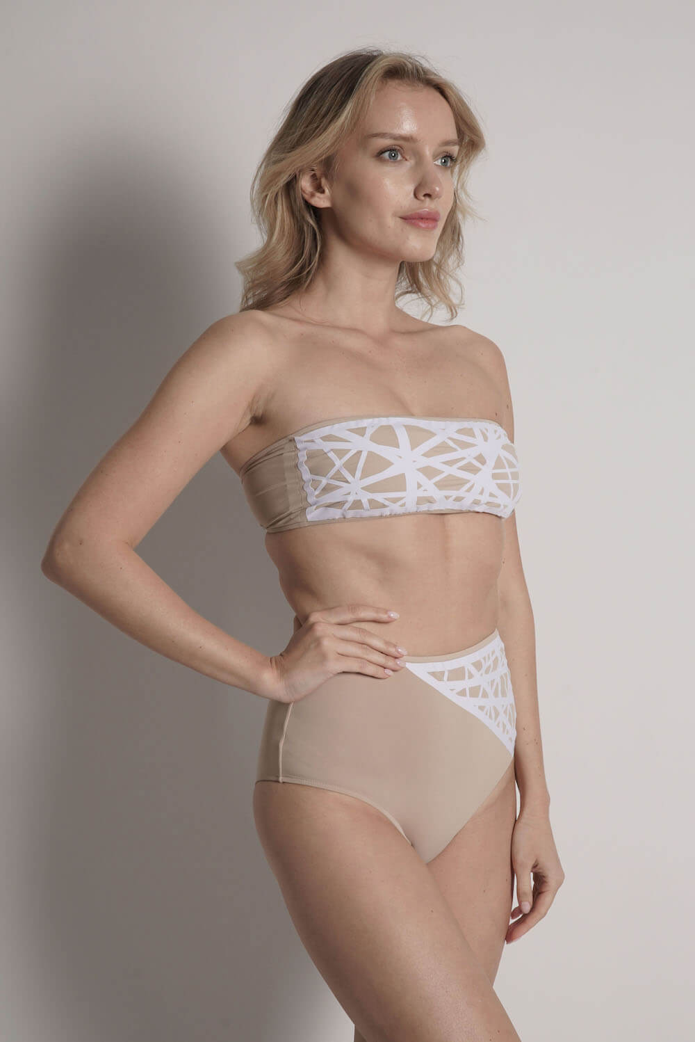 Side of Lillian high waisted bikini bottom in camel with white laser details