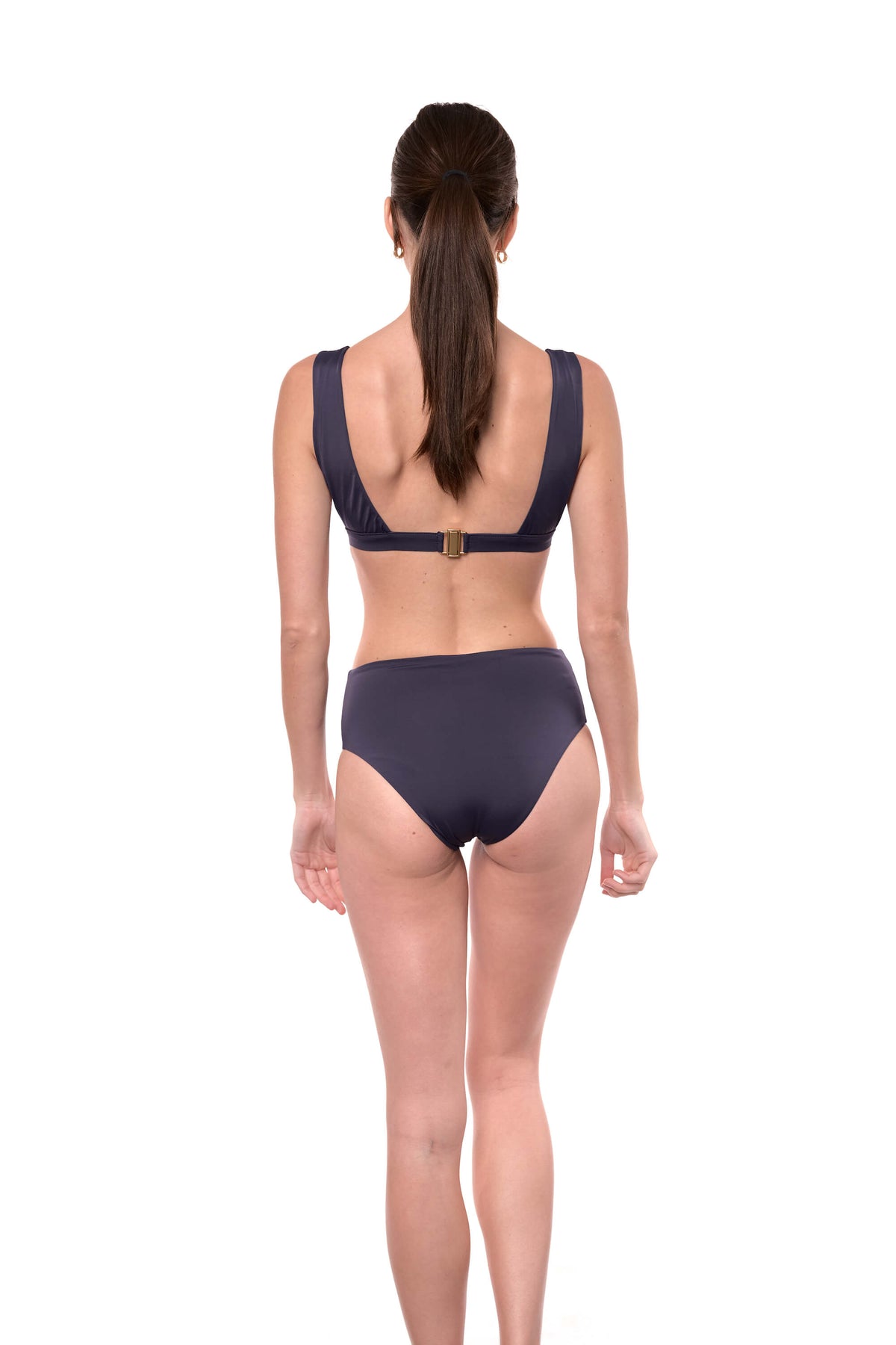 model shows the back of the Serena bikini bottom in navy blue.