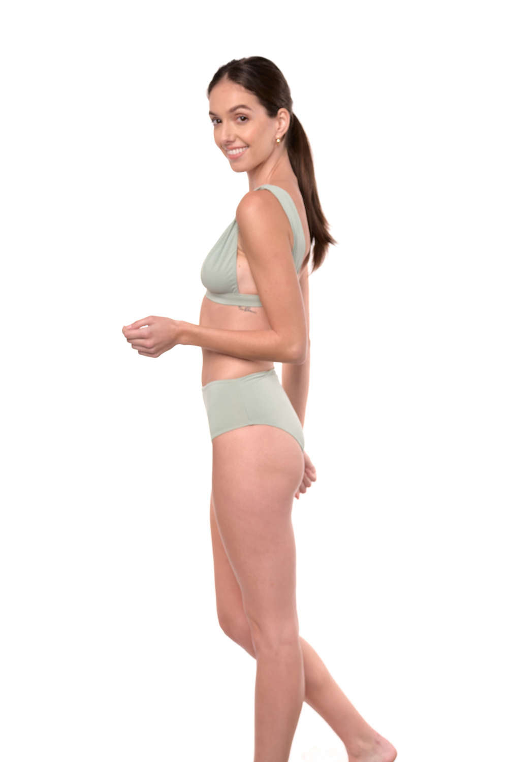 Model shows the side of the Natalie bikini top in sage green