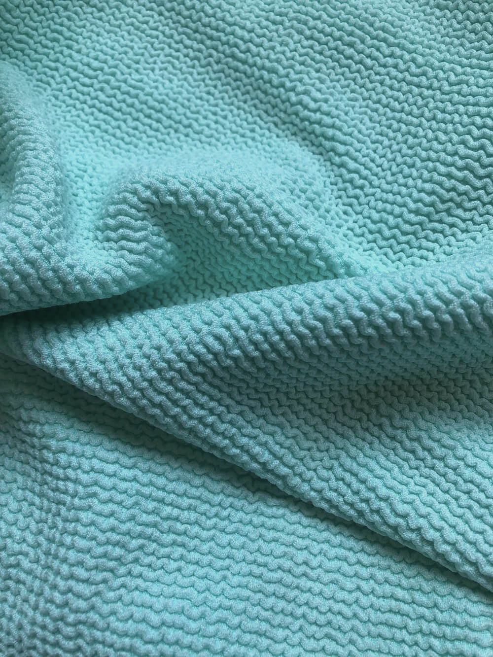 Close image of the textured fabric in the Jenna bottom aqua