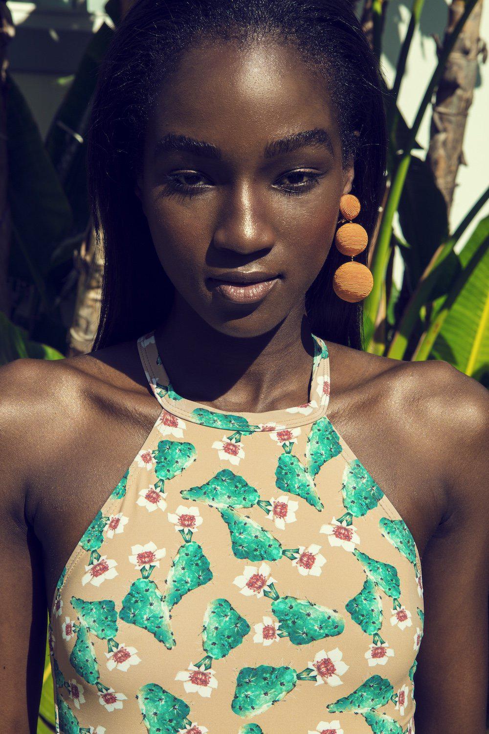 Model shows the top detail of the Denise cactus swimsuit.