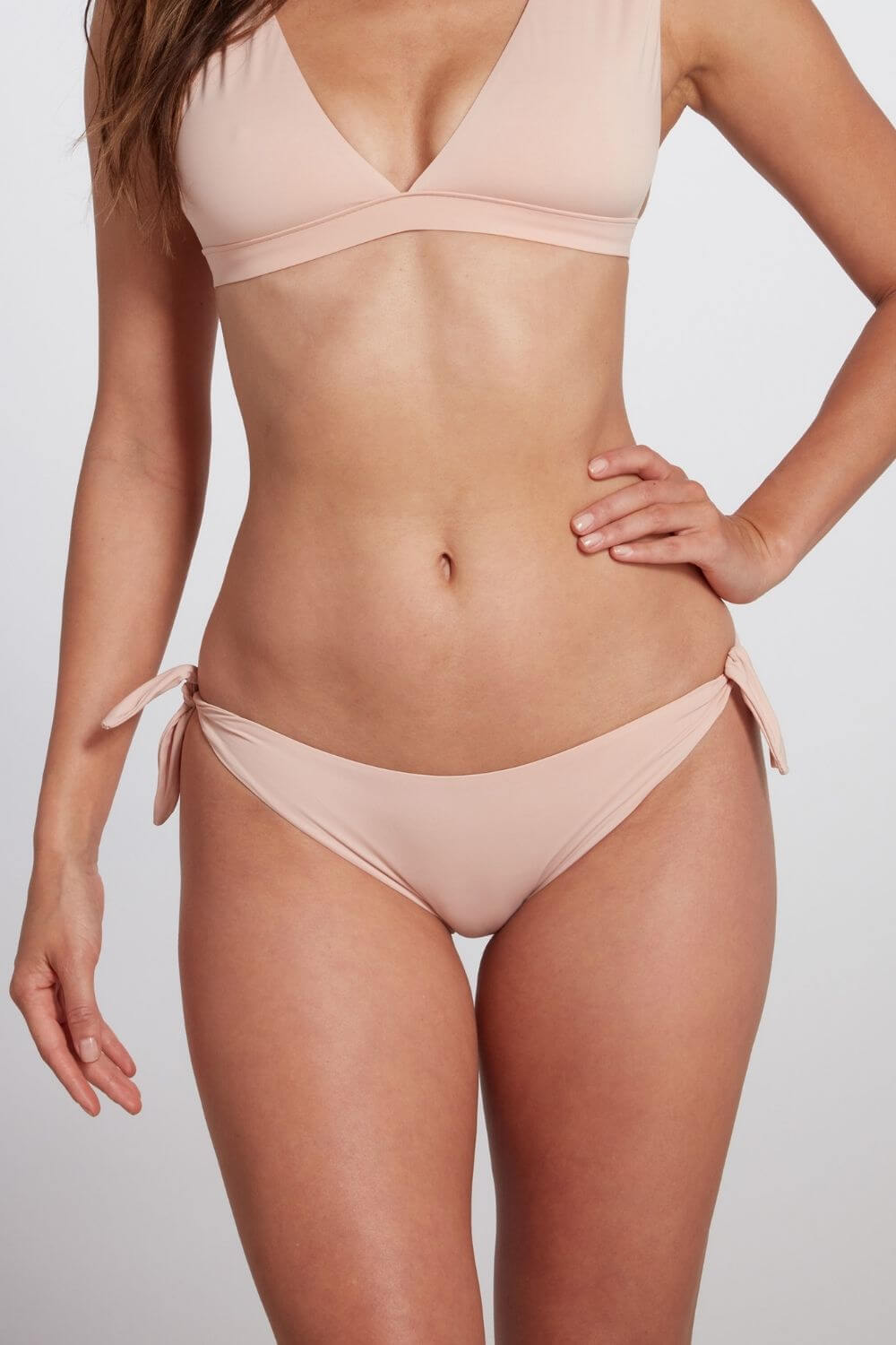 The Fanny tie-side bikini bottom in pink blush. A low rise brief with moderate coverage.