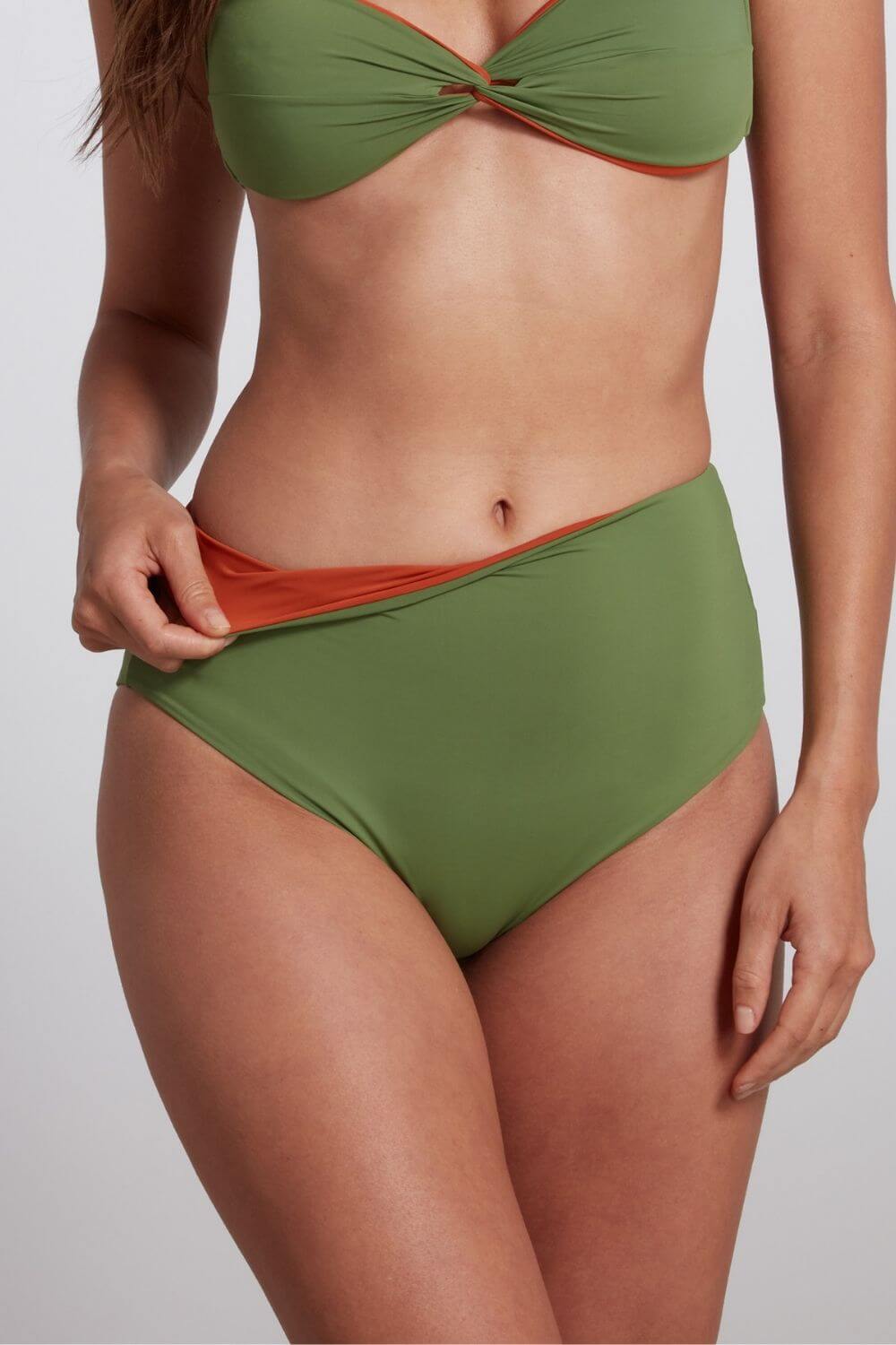 Reversible high waist bikini bottom in green and rust orange.