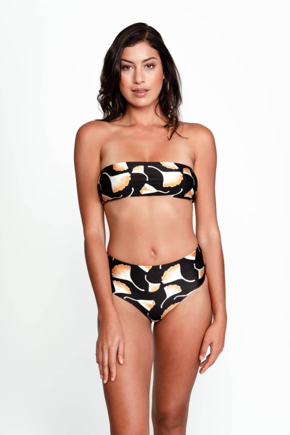 The mid-rise bikini bottom paired with a strapless bandeau bikini top in black print.